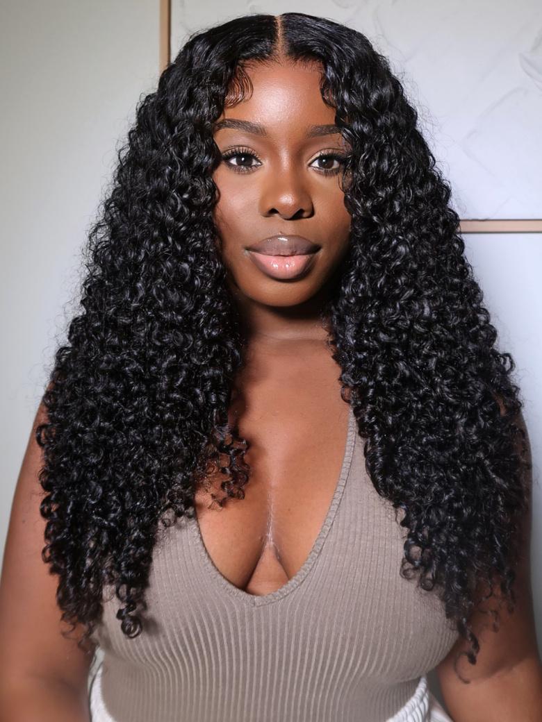 A model displays the UNice 200% Density 7x5 Bye Bye Knots Wig Glueless Lace Jerry Curly Wig With Bleached, showing a model with long curly hair wearing a grey top.