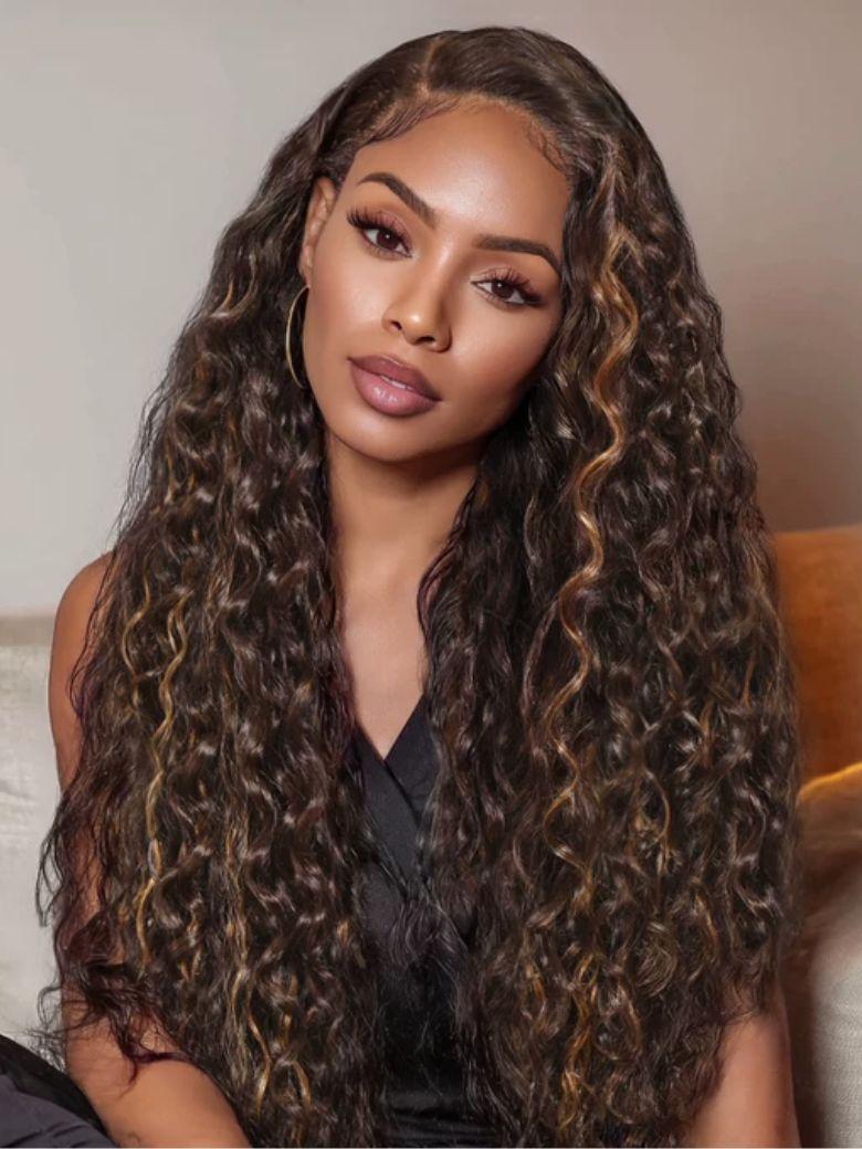 A model displays the UNice Invisi Drawstring " Bye Bye Knots 7x5 Lace Dark Toffee Brown with Auburn wig, showing a model with long curly hair sitting on a couch.