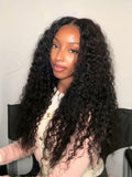 A model displays the UNice 7x5 Bye Bye Knots Lace Glueless Water Wave Grip Wig With Secure Silicone, showing a model with long curly hair sitting in a chair and water.