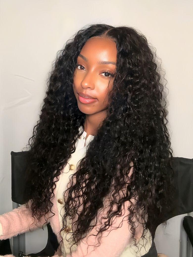 A model displays the UNice 7x5 Bye Bye Knots Lace Glueless Water Wave Grip Wig With Secure Silicone, showing a model with long curly hair sitting in a chair and water.