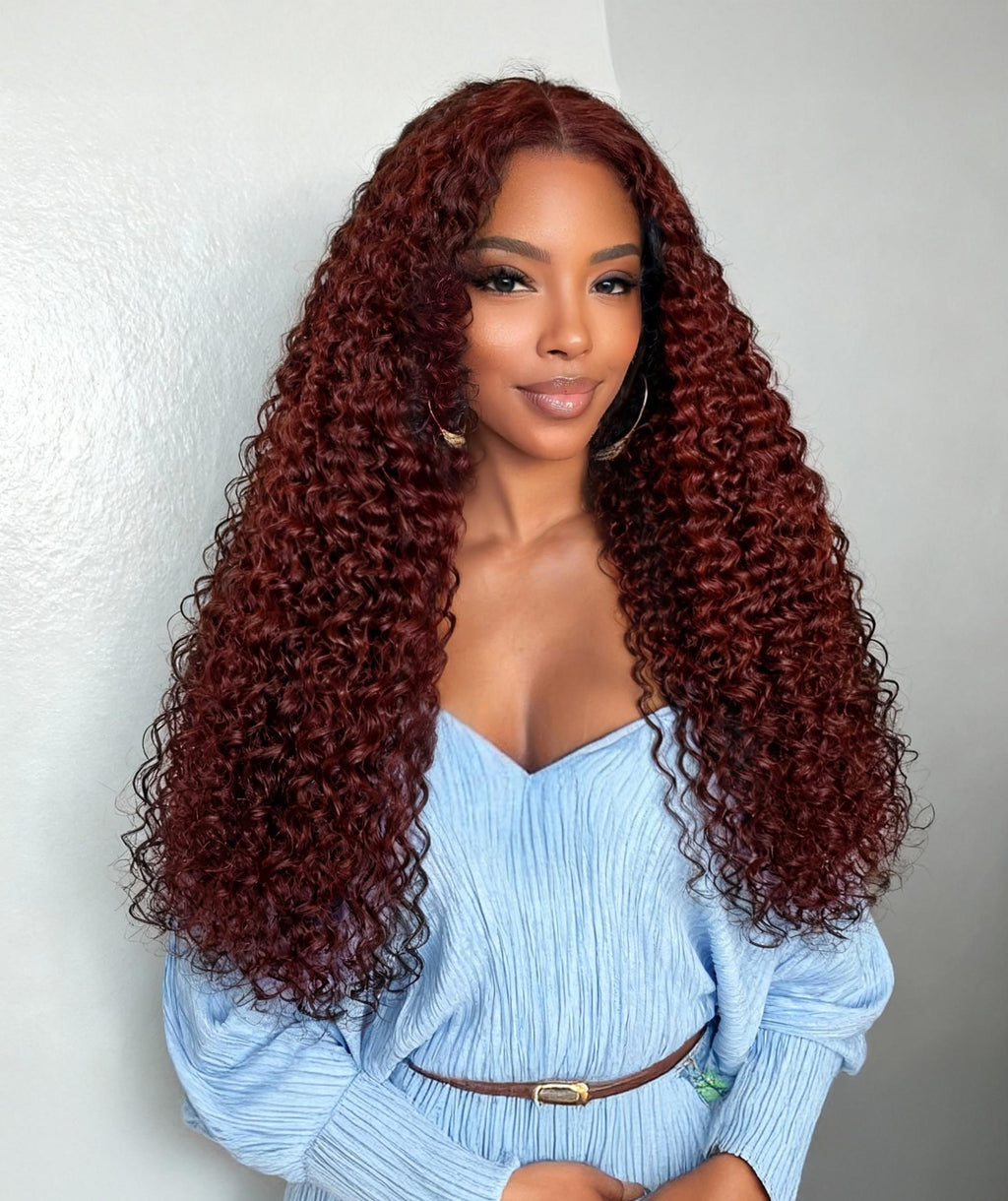 A model displays the UNice 13x4/7x5 Glueless Lace Bye Bye Knots Wig Reddish Brown Curly Wig With Bleached, showing a model with long curly hair wearing a blue shirt.