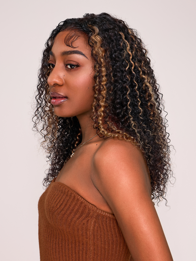 A model displays the UNice 6x4.5 Pre Cut Lace Curly Wig Put On And Go Quick Easy Black With Blonde Highlights, showing a model with long curly hair wearing a brown.