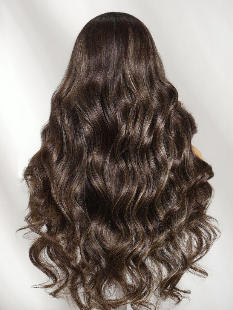 A model displays the UNice 7x5 Bye Bye Slip Lace Frontal Dark Chocolate Brown with Caramel Highlights, showing a model with long brown hair and wavy brown hair and body.