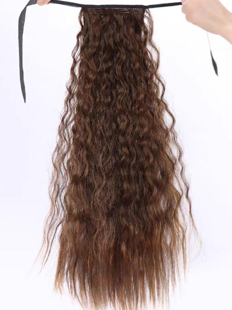 The UNice Machine-Made Dark Brown Deep Wave Clip-In Ponytail Extension visual image position 3 shows a model is holding a piece of hair | deep wave texture.
