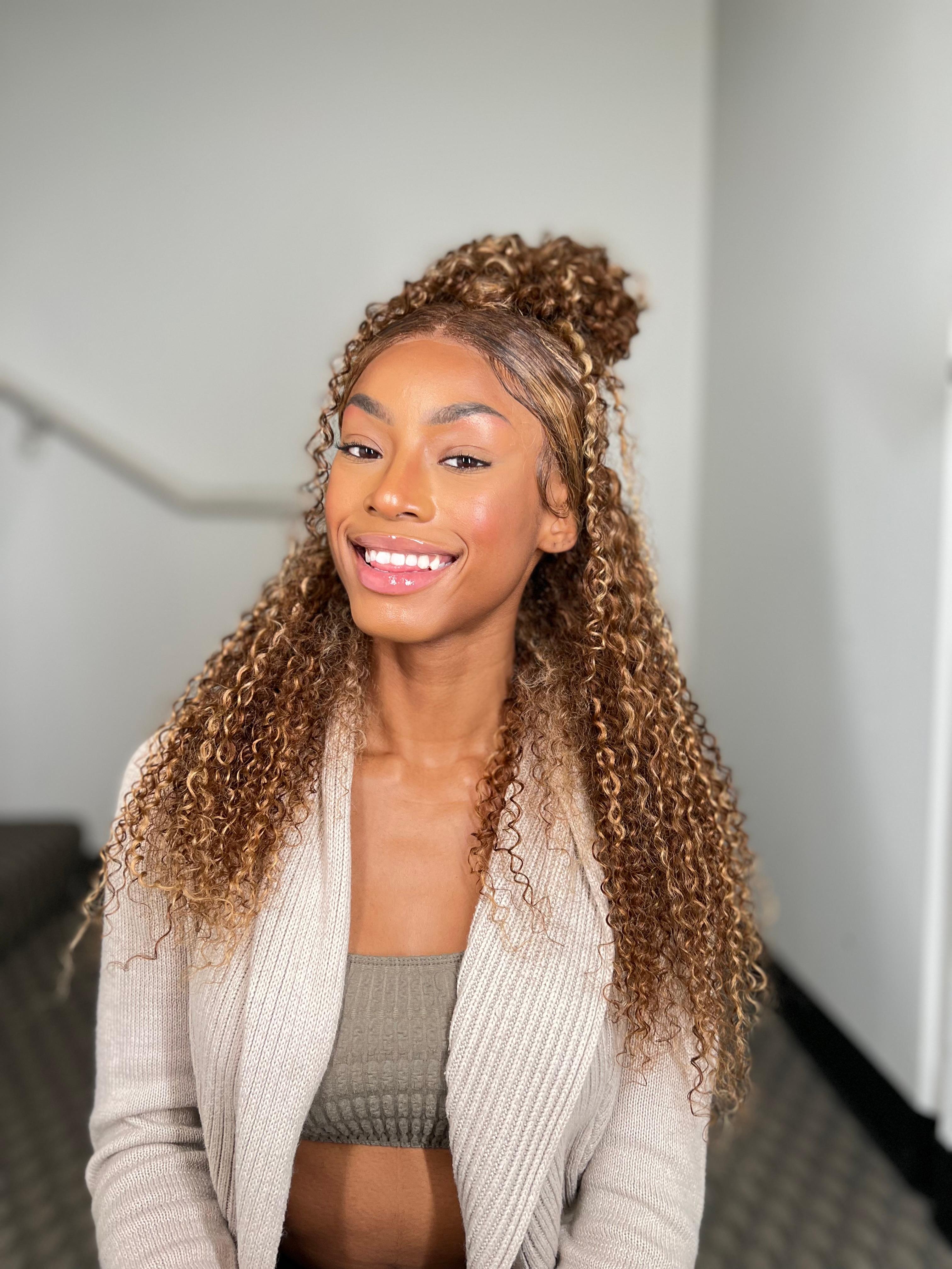 A model displays the UNice 180% Density Reddish Brown Water Wave Or Honey Blonde Jerry Curly 13x4 wig, showing a model with curly hair and a white sweater and water wave.