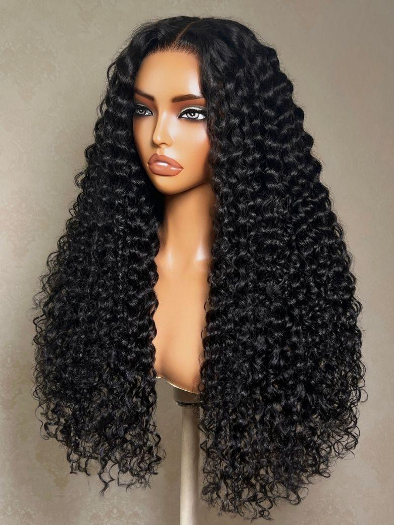 A model displays the UNice 13x4 Bye Bye Slip Lace Frontal Glueless Black Voluminous Deep Curly Wig With, showing a wig with long curly hair and curly texture, 13x4.