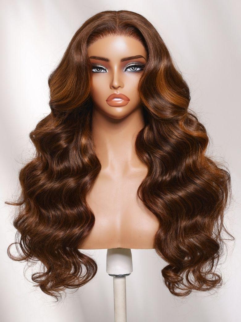 A model displays the UNice 7x5 Bye Bye Slip Lace Auburn Brown with Copper Highlights Body Wave Drawstring Wig, showing a wig with long wavy hair and body wave texture.