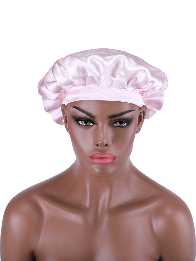 A model displays the UNice Bonus Buy Adjustable Satin Pink Night Cap Sleeping Hat For Making wig Nightcap, showing a woman wearing a pink hat with a pink bow.