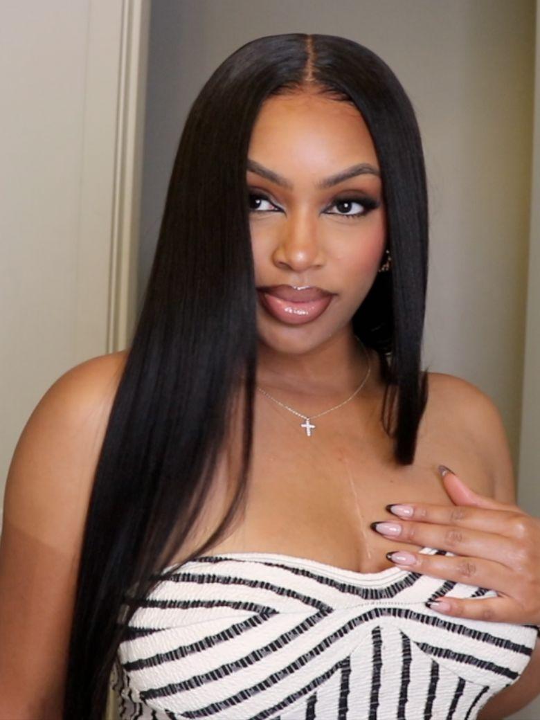 A model displays the UNice 7x5 Bye Bye Slip Yaki Straight Black Glueless Wig With Invisible Drawstring, showing a model with long black hair and a white top and straight.