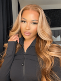 A model displays the UNice 7x5 Glueless Lace Bye Bye Knots Wig Pre-Cut Honey Blonde Body Wave Wig, showing a model with long blonde hair and a black jacket and body wave.