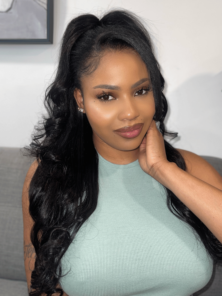 A model displays the UNice InvisiBlend V part Natural Black Glueless Body Wave Wig Protect Your Natural Hair, showing a model with long black hair and a green top.