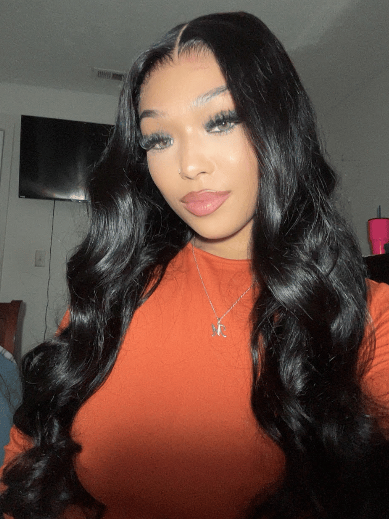 A model displays the UNice 20"-24" UNice 13x4 Pre-Everything HD Lace & Transparent Lace Front 3D Body wig, showing a model with long black hair and a red shirt and body.