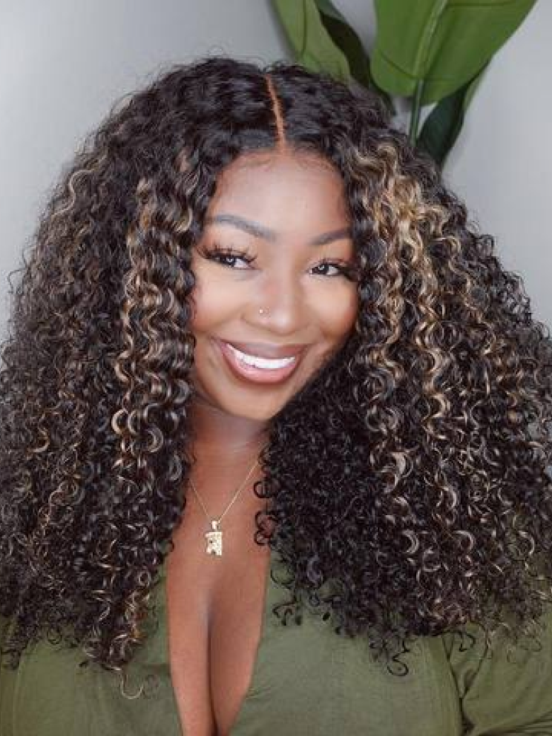 A model displays the UNice 22''=119 Bye Bye Knots Wig 7x5 Glueless Lace Black With Blonde Highlights, showing a model with long curly hair wearing a green shirt.