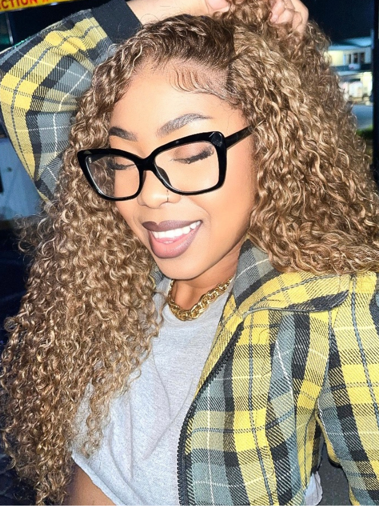 A model displays the UNice Trending Curly Hair TL412# Color 3 Pieces Human Hair Weave On Sale, showing a model with curly hair and glasses and curly texture.