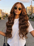A model displays the UNice 7x5 Bye Bye Slip Lace Auburn Brown with Copper Highlights Body Wave Drawstring Wig, showing a model with long brown hair and sunglasses.