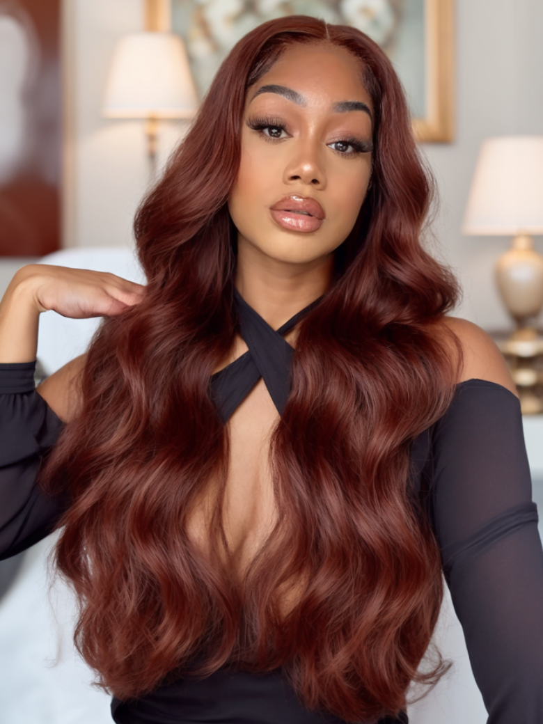 A model displays the UNice 7x5 Byebye Knots Lace Reddish Brown Body Wave Bleached Knots Blend Seamless Wig, showing a model with long red hair and a black top and body.
