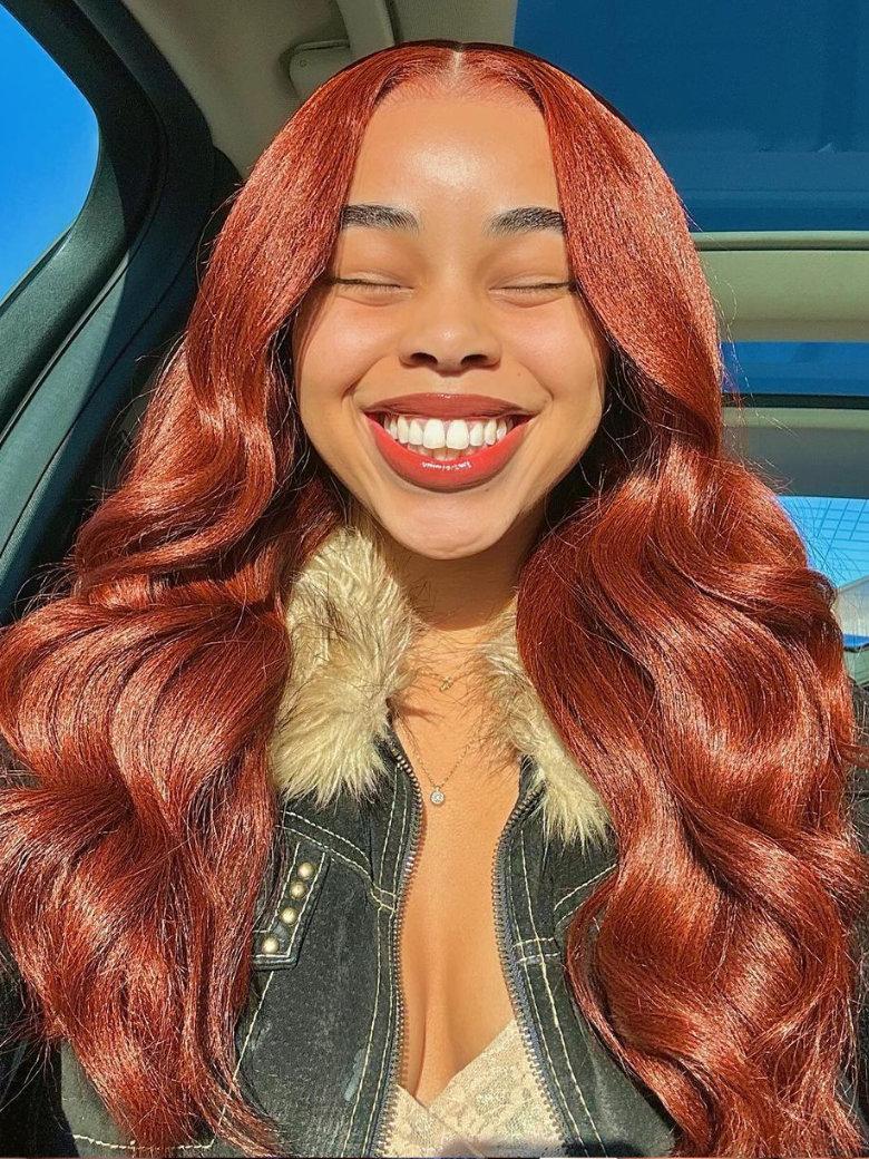 A model displays the UNice Warm and Sophisticated Reddish Brown Hair Paired With Yaki Textur7x5 Upgrade, showing a model with red hair and a black jacket and yaki.