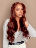 A model displays the UNice Reddish Brown Straight 1Pc 100% Remy Human Hair Bundle, showing a model with long red hair and a white shirt and straight texture, reddish.