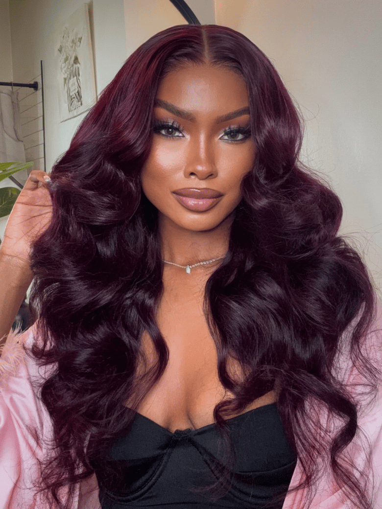 A model displays the UNice Purple Black Cherry Loose Wave Invisi Drawstring 7x5 Bye Bye Knots Lace wig, showing a model with long dark red hair and loose wave texture.