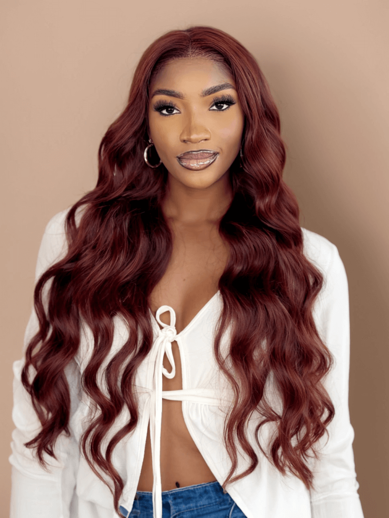 A model displays the UNice Reddish Brown Body Wave 1Pc 100% Remy Human Hair Bundle, showing a model with long red hair and a white shirt and body wave texture, reddish.