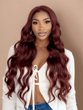 A model displays the UNice Reddish Brown Body Wave 1Pc 100% Remy Human Hair Bundle, showing a model with long red hair and a white shirt and body wave texture, reddish.