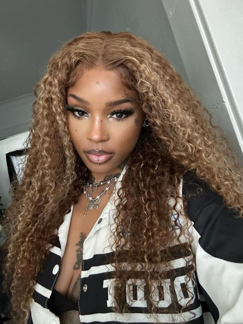 A model displays the UNice 13x4 Pre-Everything Lace Frontal Honey Blonde Highlights Jerry Curly Wig Real, showing a model with long curly hair wearing a black and white.