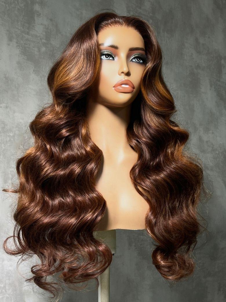 A model displays the UNice 7x5 Bye Bye Slip Lace Auburn Brown with Copper Highlights Body Wave Drawstring Wig, showing a long wavy brown wig with brown.