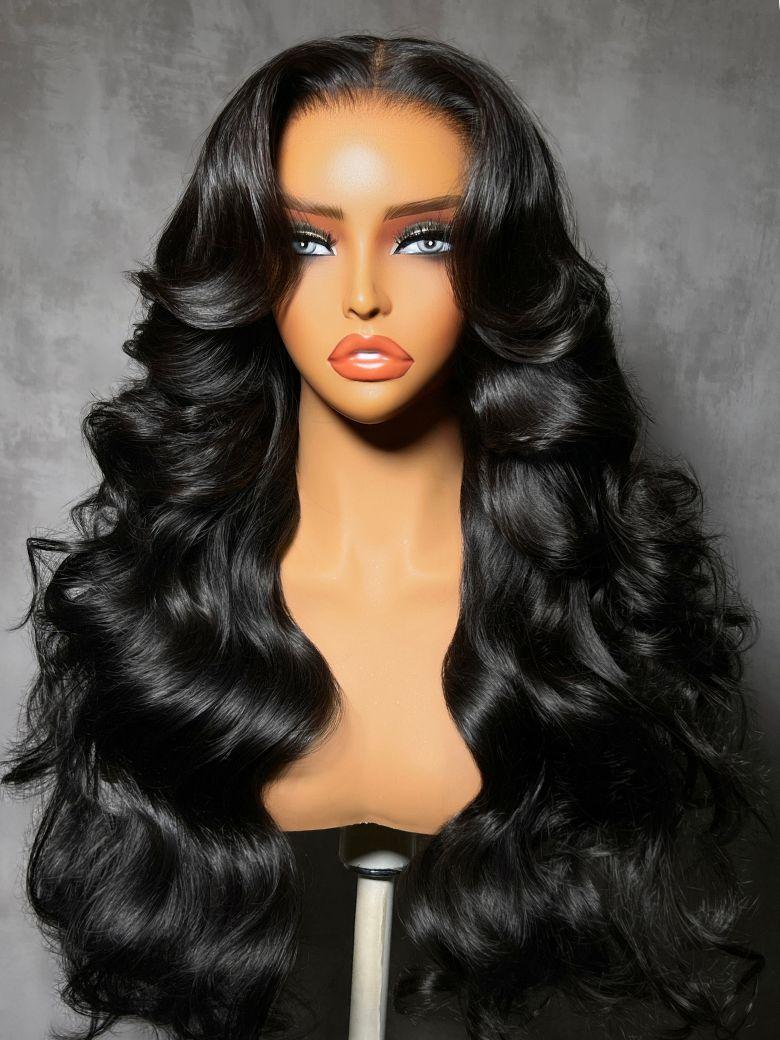 A model displays the UNice Bye Bye Slip 7x5 Glueless Lace Body Wave Lace Front Wig Invisi Drawstring, showing a wig with long black hair and body wave texture, 7x5.