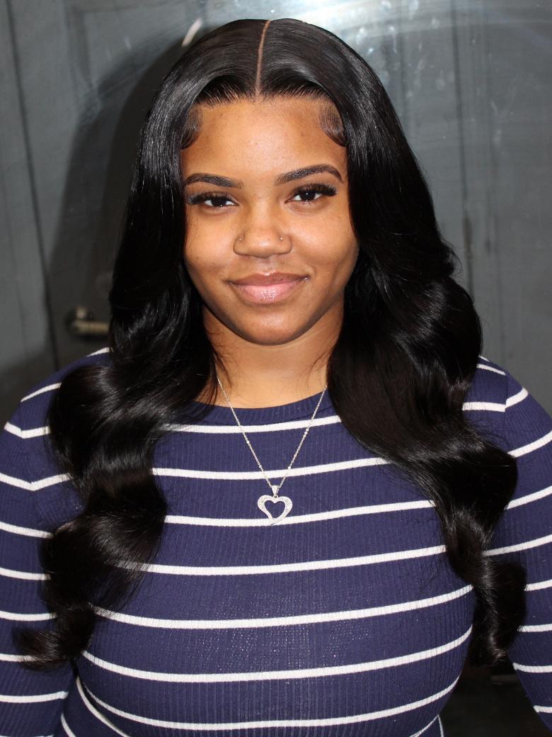 A model displays the UNice 7x5 Lace Bye Bye Knots & 13x6 Lace Frontal Black Body Wave Pre-Everything Wig, showing a model with long black hair and a blue sweater.