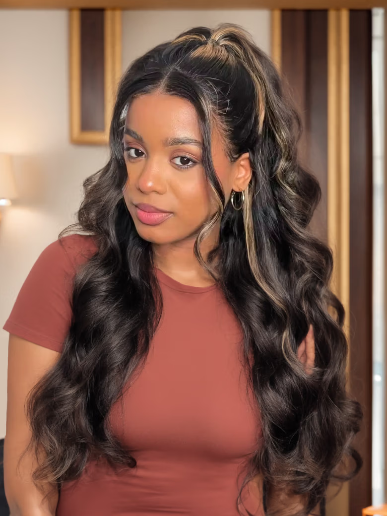A model displays the UNice 22-24" Bye Bye Knots wig 7x5 / 6X4.5/ 13X4 Pre-Cut Lace Honey Brown, showing a model with long hair and a red top and jerry curl texture.