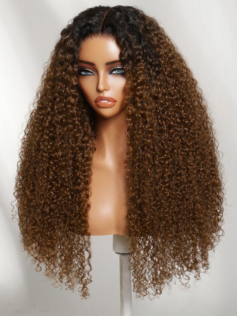 A model displays the UNice 7x5 Bye Bye Slip Lace Warm Caramel Brown with Dark Roots Natural Afro Curly wig, showing a wig with long curly hair on a mann and curly.