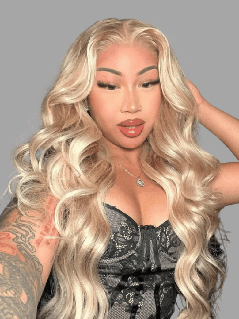 A model displays the UNice 13x4 Lace Front Body Wave Glossy Blonde Pre-Everything Wig, showing a model with long blonde hair and tattoos and body wave texture, 13x4.