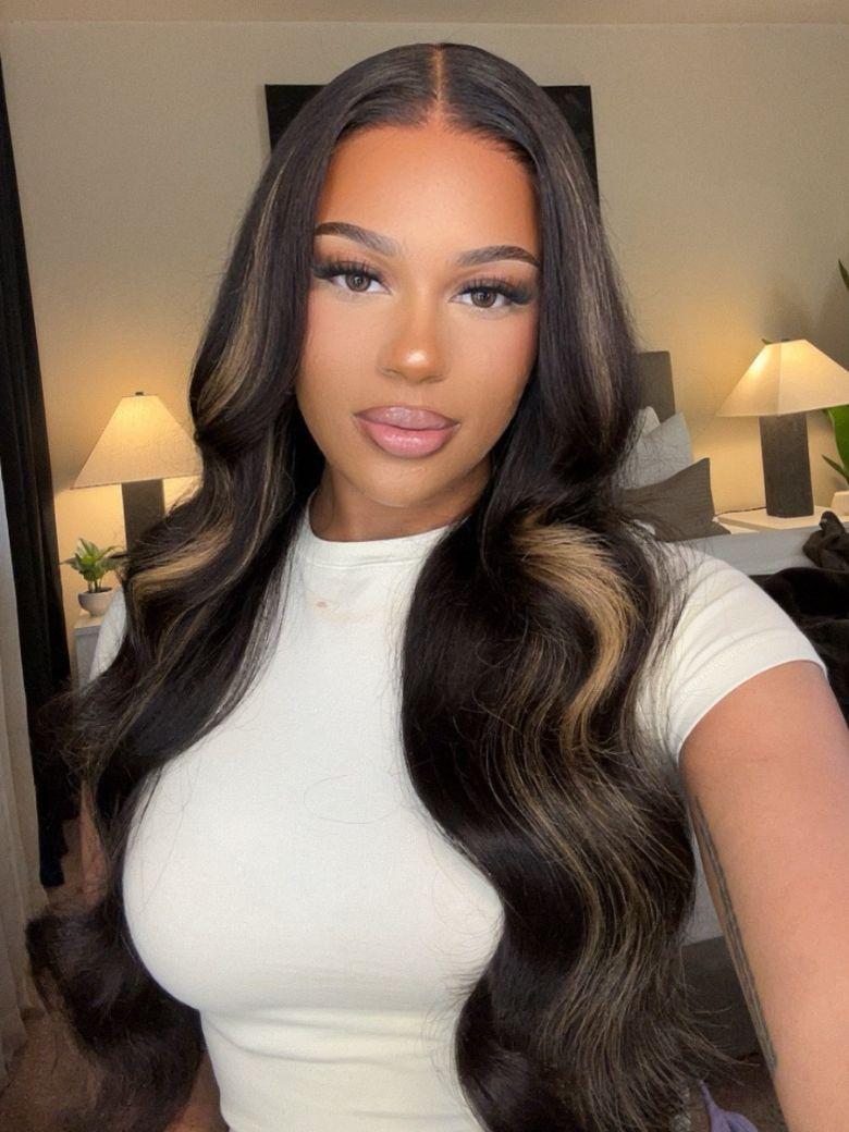 The UNice 7x5 Bye Bye Knots Glueless Lace Wig Black With Blonde Highlights 3D Body Wave visual image position 4 shows a model with long hair wearing a white top | body.