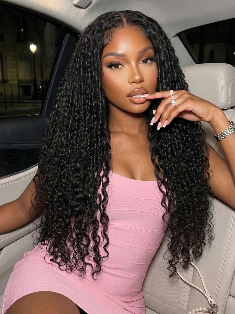 A model displays the UNice 7x5 Bye Bye Slip Lace Black Defined Mixed Curly Glueless Wig with Invisi, showing a woman sitting in a car wearing a pink dress and curly.