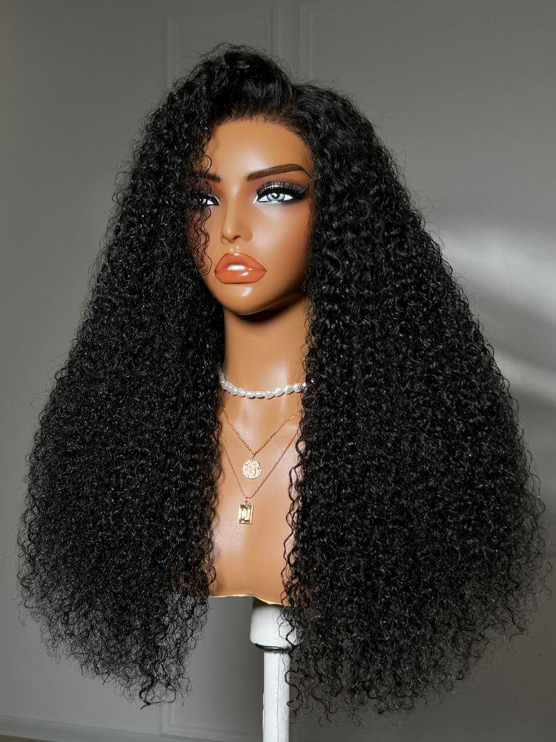 The UNice Bye Bye Knots 7x5 Lace Jerry Curl 150% Density Wig with Lived-In Coils product image shows a wig with long curly hair on a mann and jerry curl texture, defined.