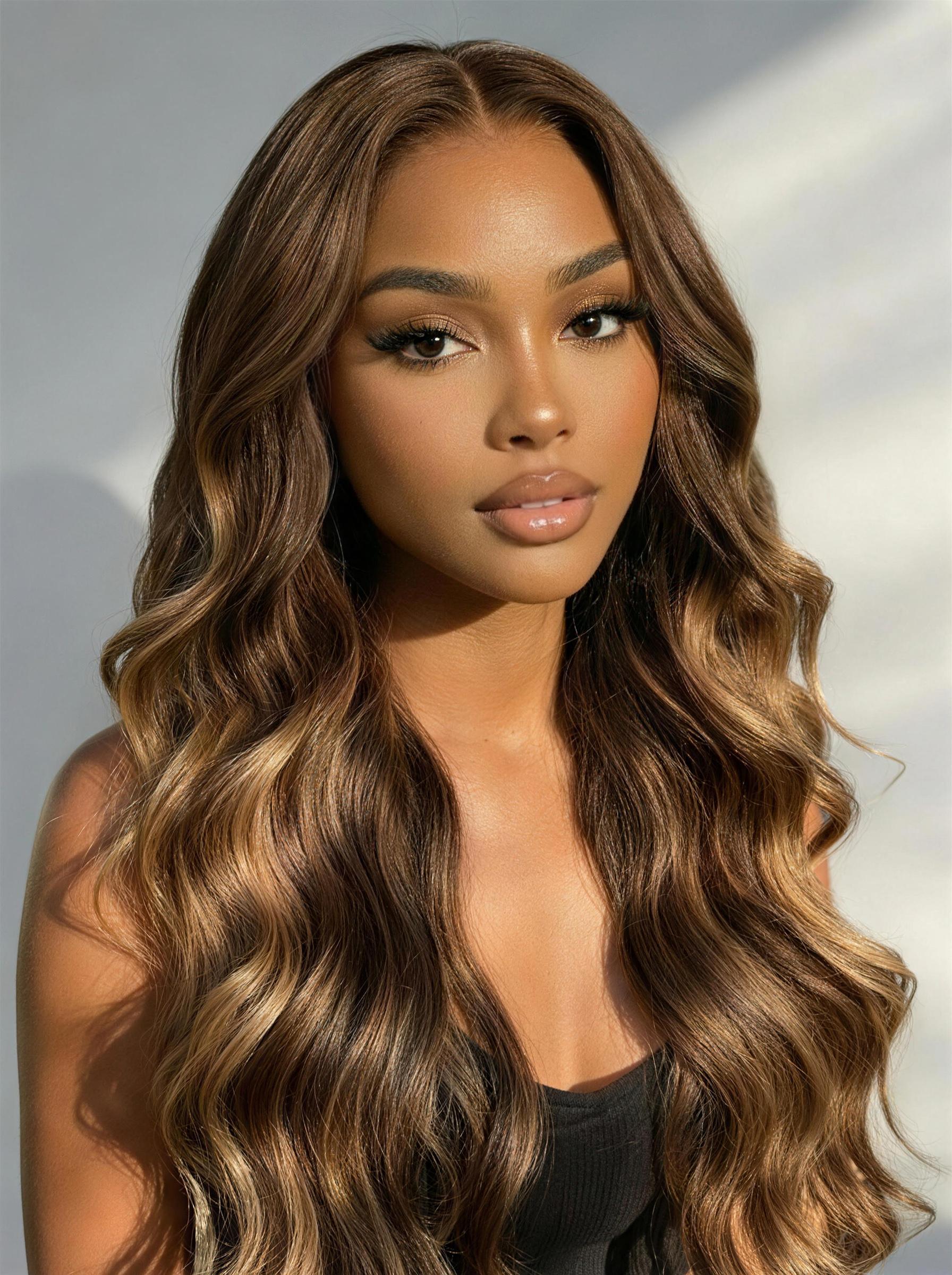 A model displays the UNice Bye Bye Slip 7x5 Lace Deep Brown with Caramel Higlights Loose Wave Drawstring wig, showing a model with long brown hair and a black top.