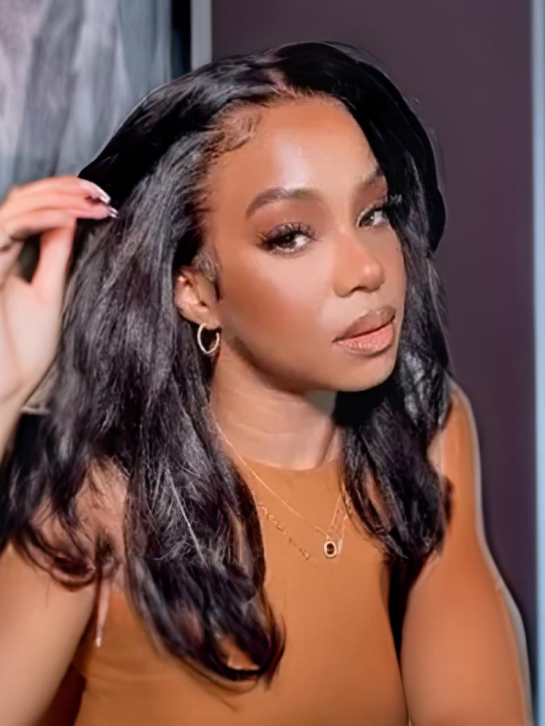 A model displays the UNice EasiContour V Part Glueless Kinky Straight Bouncy Natural Black Wig, showing a model is brushing her hair in a mirror and kinky straight.