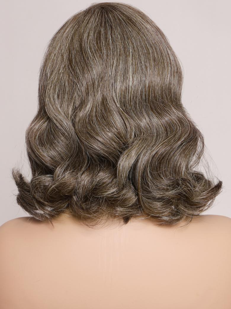 A model displays the UNice SLOANNE- 12" MONO & SWISS LACE BODY WAVE HUMAN HAIR WIG, showing a model with a long brown hair and body wave texture, lace finish.