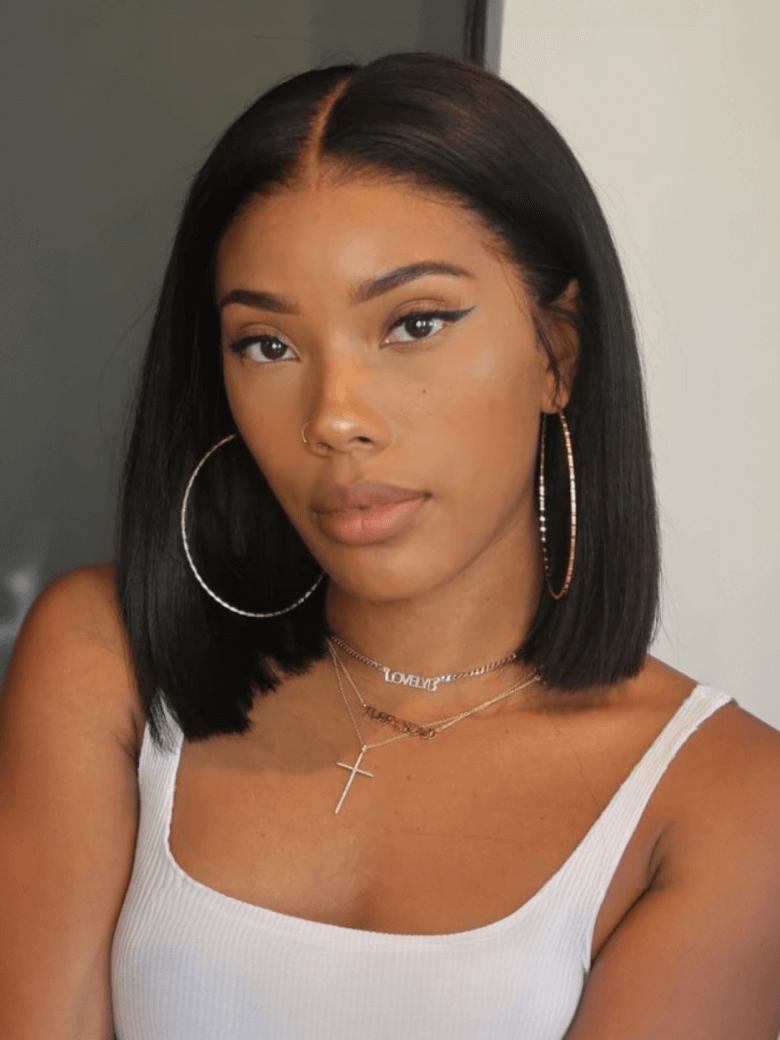 A model displays the UNice 7x5 Bye Bye Knots & 4x4 Lace Closure Black Bob Wig With Side Swept Bangs, showing a model with long black hair wearing a white top and hoop.