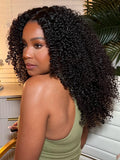 A model displays the UNice Hot Lace Part Wig Breathable Kinky Curly wig Natural Hairline, showing a model with curly hair in a kitchen and kinky curly texture, curly.