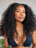 A model displays the UNice 200% Density Glueless V Part 0 Skill Needed Wig Beginner Friendly Natural, showing a model with long curly hair wearing a black bikini top.
