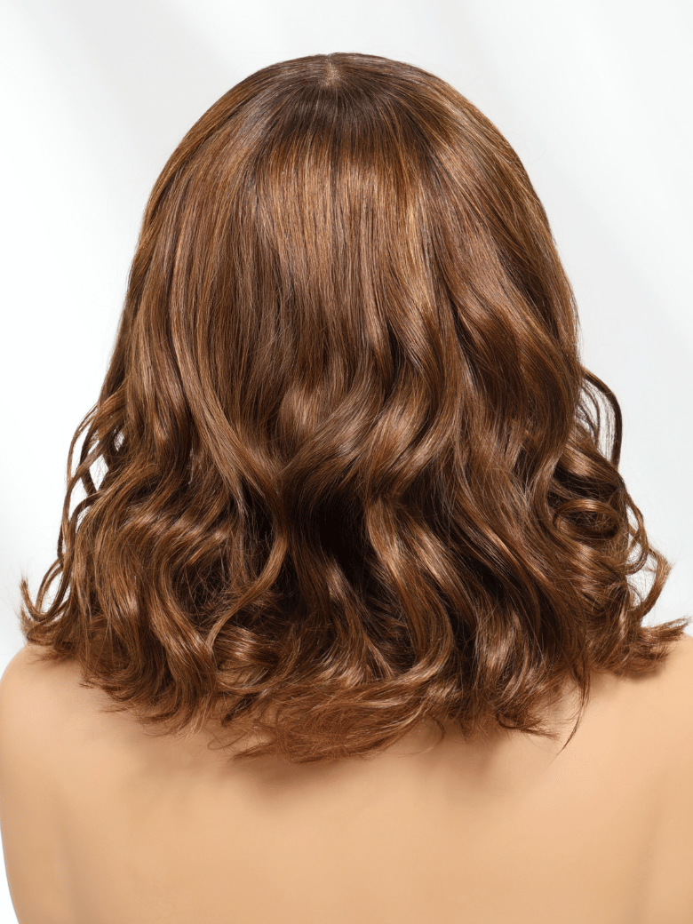 A model displays the UNice Chic Brown Bob Wig 4x2 Lace with Bangs Soft Waves Effortless Style Wig, showing a model with long brown hair and a brown top and 4x2, lace.