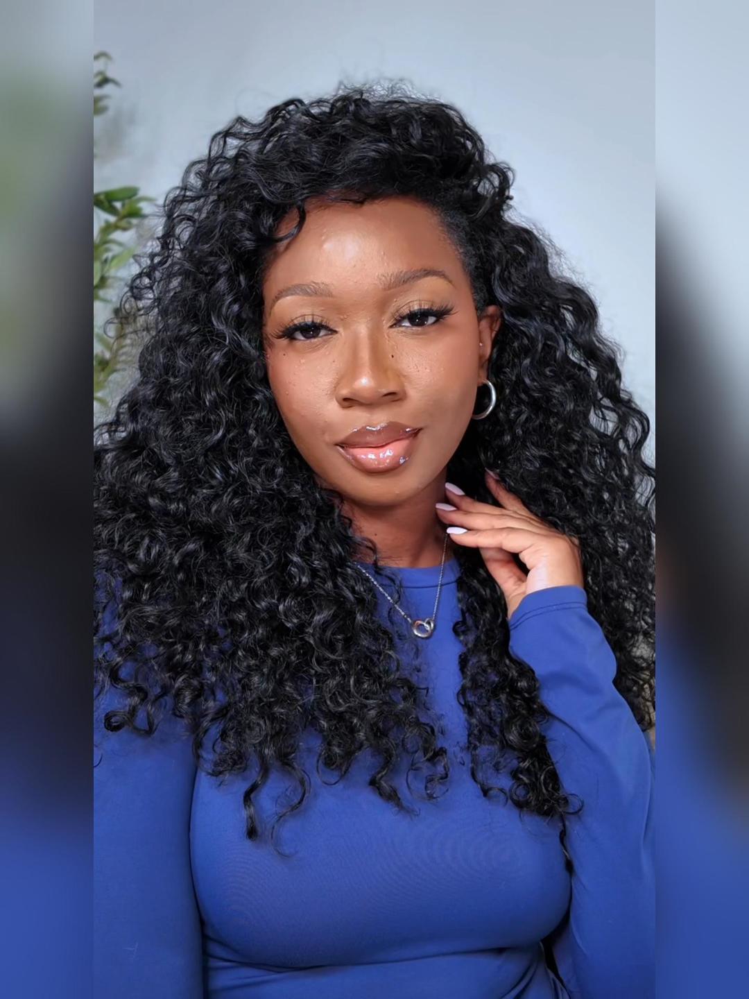 A model displays the UNice InvisiBlend V Part Bouncy Water Wave Curly Seamless Blending Wig With, showing a model with long curly hair and blue top and water wave.