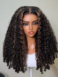 A model displays the UNice Bye Bye Slip 7x5 Lace Warm Brown with Beige Blonde Ribbon Highlights Layered wig, showing a model with blonde hair and a black top sitting.