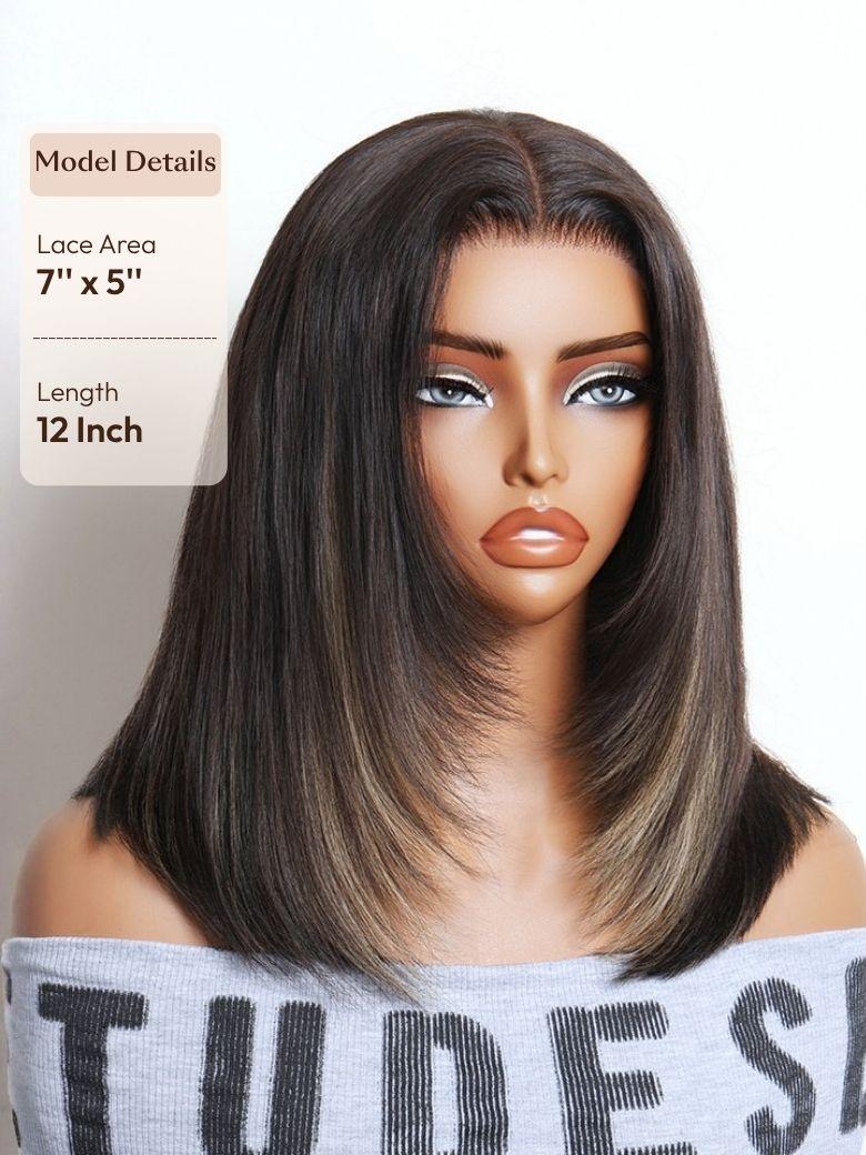 A model displays the UNice Bye Bye Slip 7x5 Lace Warm Brown with Beige Blonde Ribbon Highlights Layered wig, showing a model with blonde hair and a black top.