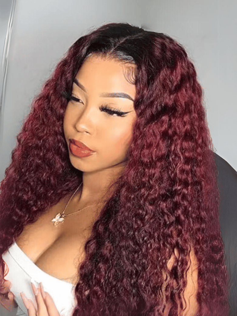 A model displays the UNice Beginner Friendly V Part Burgundy Ombre With Dark Roots Curly Wig 150% Density, showing a model with long red hair and a white shirt and curly.