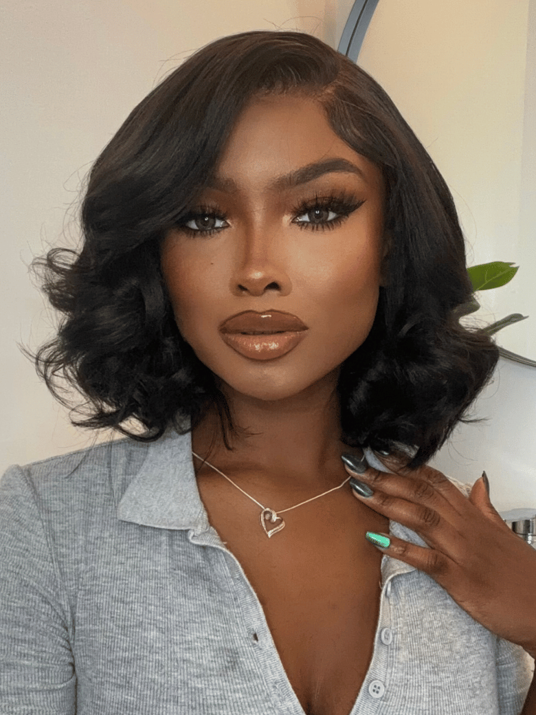 A model displays the UNice 13x4 Lace Front 180% Density Big Loose Wave Black Shoulder Length Wig, showing a model with long hair and a grey shirt and loose wave texture.
