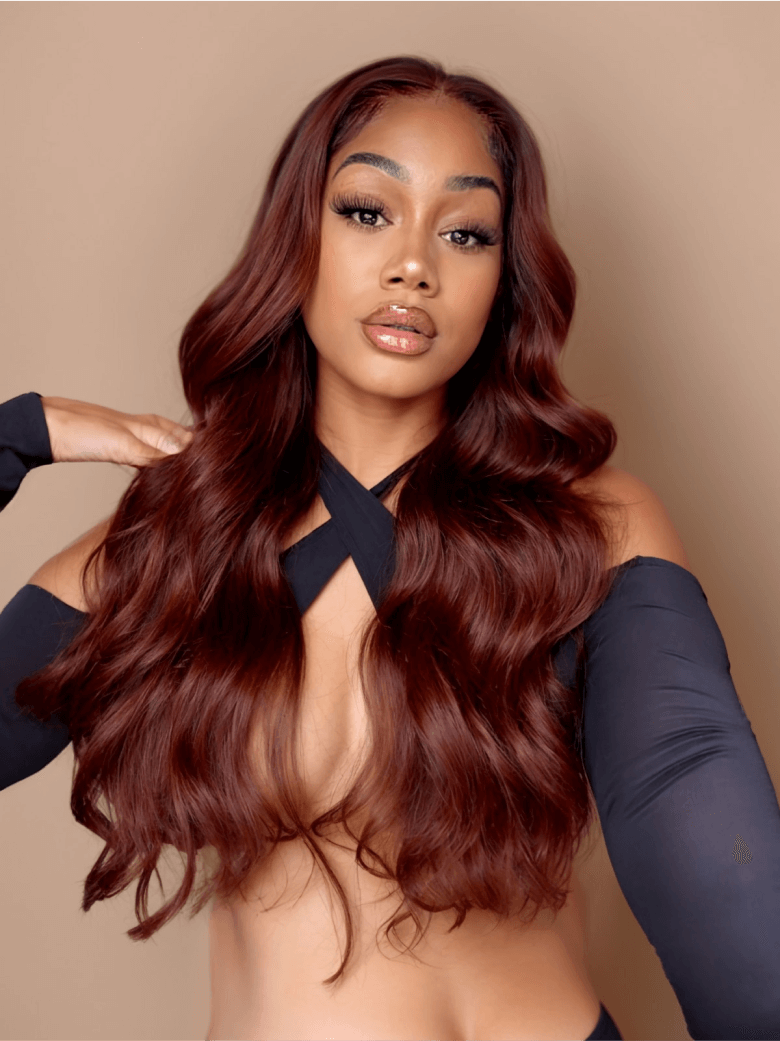 A model displays the UNice Dark Auburn Body Wave Remy Human Hair 4x4 Free Part Closure, showing a model with long red hair and a black top and body wave texture, 4x4.