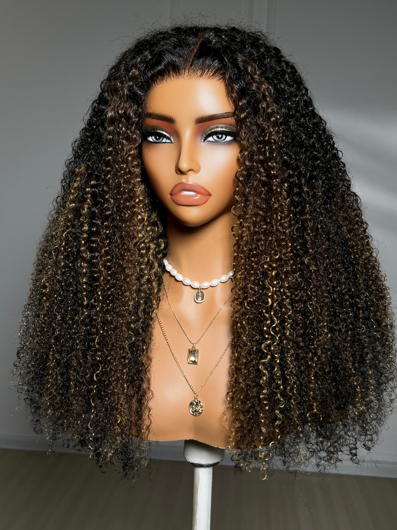A model displays the UNice 7x5 Bye Bye Slip Lace Black with Blonde and Caramel Highlights Full Curly Wig, showing a wig with curly hair on a mann and curly texture.