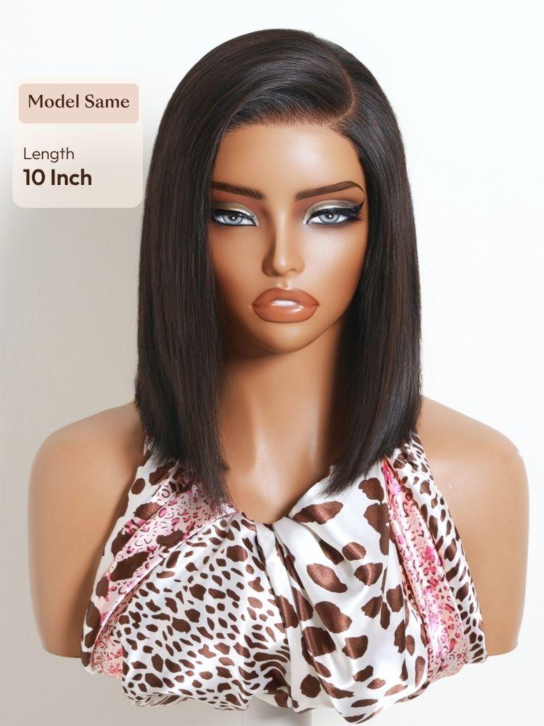 A model displays the UNice Bye Bye Slip 6x4 Lace Glueless Natural Black Side Part Sleek Blunt Cut Bob Wig, showing a model with long hair wearing a brown and pink scarf.